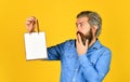 Bearded man hold paper bag. presents. delighted man shopping online. surprised hipster making purchases at electronics