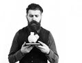 Bearded man holding notepad and moneybox with sad face