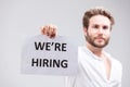 Bearded man holding up a We`re Hiring sign Royalty Free Stock Photo