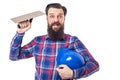 Bearded man holding used masonry tool