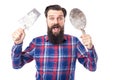 Bearded man holding used masonry tools