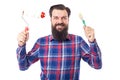 Bearded man holding used paint tools