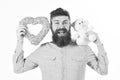 Bearded man holds symbols of love.