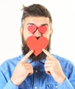 Bearded man holds symbols of love.