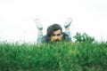 Bearded man laying on green grass