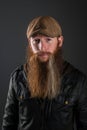 Bearded man with leather jacket and cap. Royalty Free Stock Photo