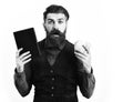 Bearded man holding notepad and moneybox with surprised face