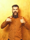 Bearded man, long beard. Brutal caucasian shouting hipster with moustache in brown shirt holding alcoholic red shot on