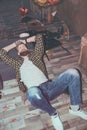 Bearded man lying on floor in messy room after party Royalty Free Stock Photo