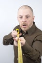 Bearded man makes a measurement tape measure centimeter Royalty Free Stock Photo