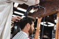 bearded man near hairstylist drying his