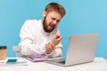 Bearded man office worker in white shirt grimacing feeling tingling, numbness and pain in wrist working on laptop, suffering Royalty Free Stock Photo