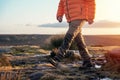 Man in orange jacket relaxing alone on the top of mountain and drinking hot coffee at sunrise. Travel Lifestyle Royalty Free Stock Photo