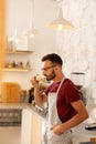 Bearded man owning coffee room standing and drinking coffee Royalty Free Stock Photo