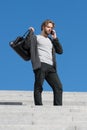 Bearded man with phone and fashionable sport bag Royalty Free Stock Photo