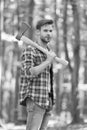 Bearded man in plaid shirt with jeans carry large splitting axe in summer wood natural environment, lumberjack Royalty Free Stock Photo