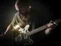 Bearded man playing bass guitar Royalty Free Stock Photo
