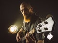 Bearded man playing bass guitar with spotlight Royalty Free Stock Photo