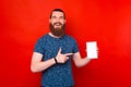 Bearded man is pointing at the screen of a tablet. Royalty Free Stock Photo