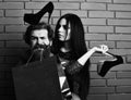 Bearded man and pretty sexy woman with shopping bag, shoes Royalty Free Stock Photo