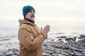 Man relaxing alone on the seaside on cold winter day. Travel Lifestyle concept Royalty Free Stock Photo