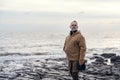 Man relaxing alone on the seaside on cold winter day. Travel Lifestyle concept Royalty Free Stock Photo