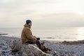 Bearded Man relaxing alone on seaside on cold winter day. Travel  Lifestyle concept Royalty Free Stock Photo