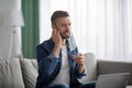 Bearded man removing face mask, scratching his beard Royalty Free Stock Photo