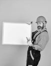 Bearded man repairman builder. Plan repair works. Visual outline. Repairman hold whiteboard copy space. Handsome