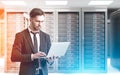 Bearded man in a server room, sunlight Royalty Free Stock Photo