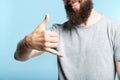 Bearded man show phone call gesture shaka sign