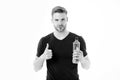Bearded man show thumbs up with bottle of water. Thirsty man with beard in tshirt hold plastic bottle. Thirst and Royalty Free Stock Photo