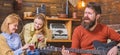 Bearded man singing heart-warming love song. Man with hipster beard playing moving melody on guitar. Musician Royalty Free Stock Photo