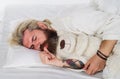Bearded man sleeping with plush teddy bear relaxing in bed. Good night. Sleepy man in pajamas sleeping in bed at home Royalty Free Stock Photo