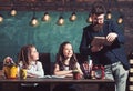 Bearded man and small girls in elementary school. Bearded teacher with beard teach schoolgirls in classroom Royalty Free Stock Photo