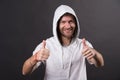 Bearded man smile with thumbs up. Happy man with beard wear hood. Fashion model in hoodie tshirt. Active lifestyle and