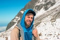 A bearded man smiles on the slope of the mountains. Snow top