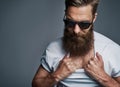Bearded man in sunglasses showing chest hair Royalty Free Stock Photo