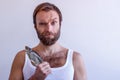 Bearded man in a T-shirt with a vobla on a white background Royalty Free Stock Photo