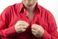 Bearded man takes off undress red shirt