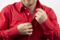 Bearded man takes off undress red shirt