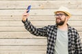 Bearded man takes selfie with smartphone during summer city break over wooden wall - selfie photos and social media app