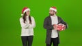 Bearded man taking away christmas box from female hands