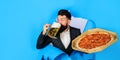 Bearded man with tasty pizza drinking mug of beer. Pizza time. Satisfied man with delicious pizza and cold beer looking