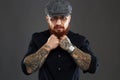 Bearded man with tattoo. brutal handsome man in hat Royalty Free Stock Photo