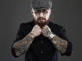 Bearded man with tattoo..brutal handsome man in hat Royalty Free Stock Photo