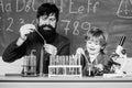 bearded man teacher with little boy. biotechnoloy research concept. father and son at school. Back to school. Explaining