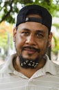 Bearded man 30 to 40 years, with flowers in his beard. Closeup portrait of one handsome smiling man with long black beard showing Royalty Free Stock Photo