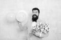 Bearded man with tulips. Spring party. Surprise party romantic proposal ideas. Present for spouse. Guy with air balloons