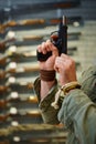 Bearded man twitches the pistol bolt in gun store Royalty Free Stock Photo